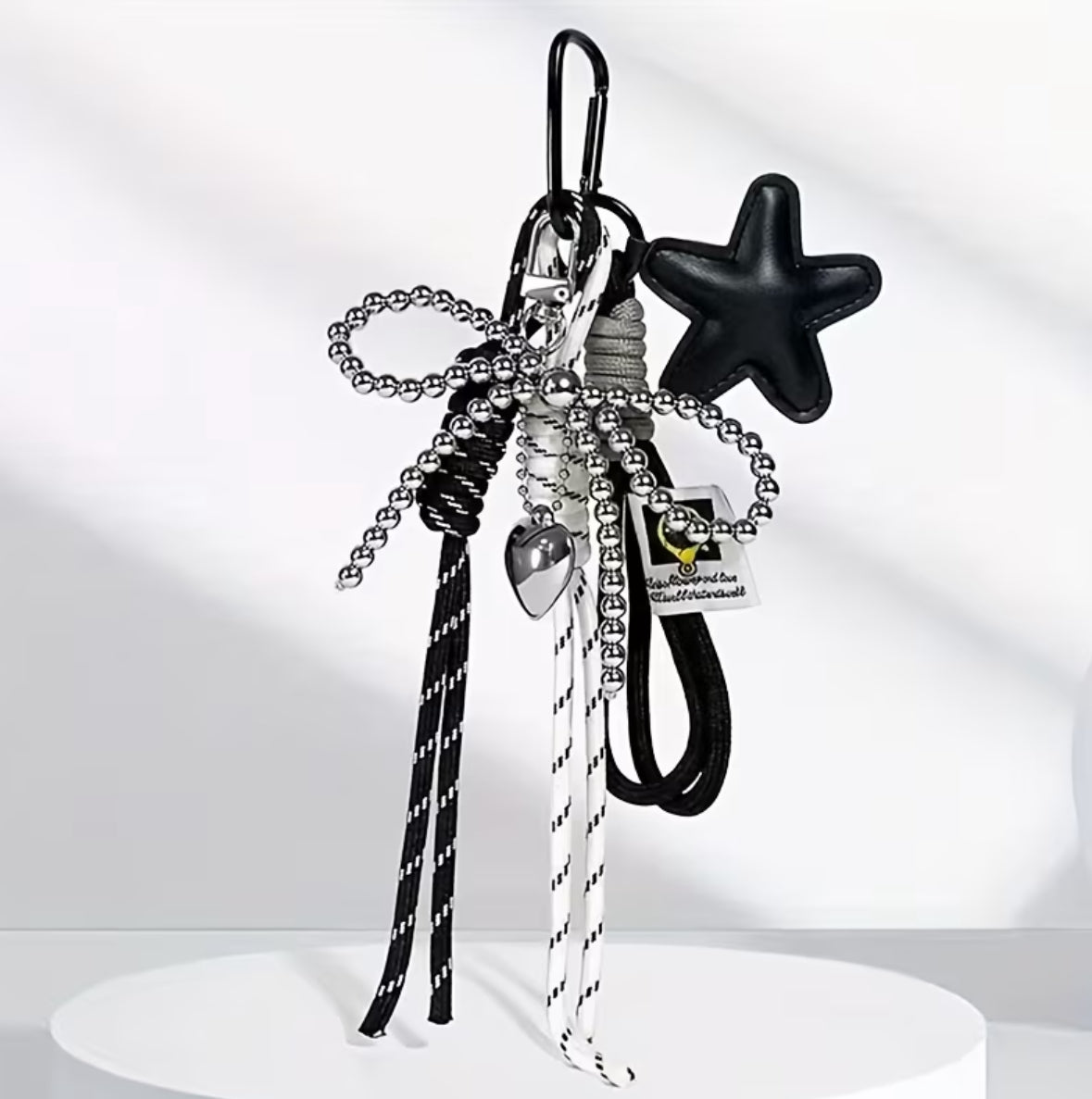 Charm estrella negra con moño plata